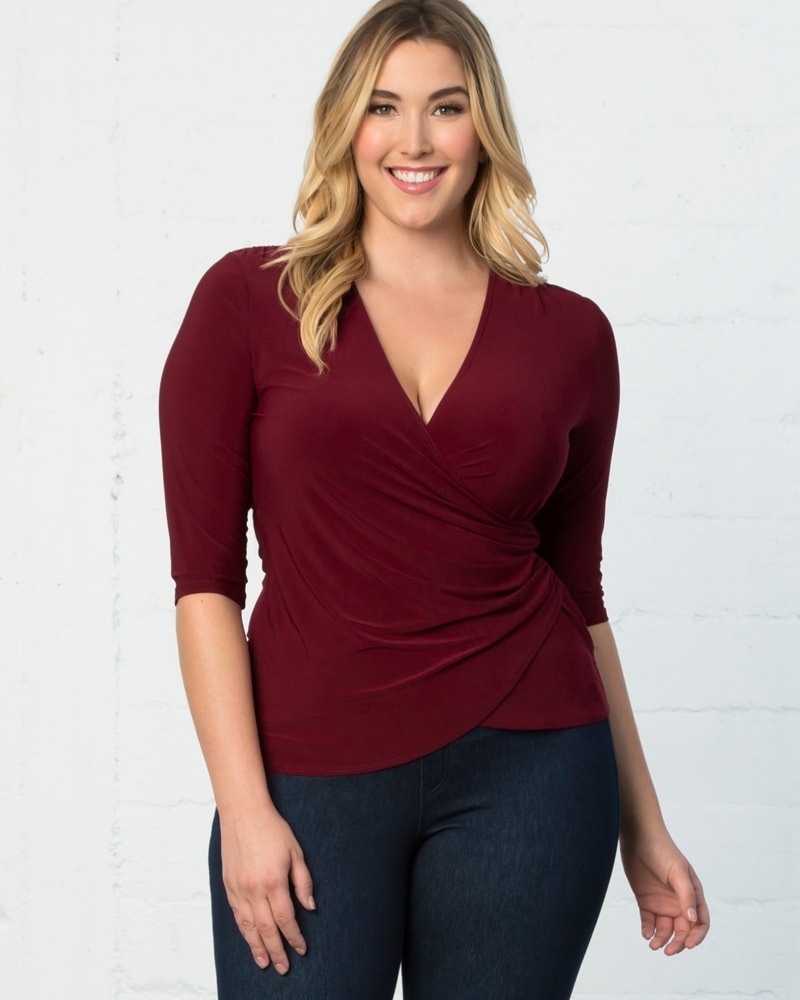 Front of a model wearing a size 0X Shanna Faux-Wrap Top in BURGUNDY by Kiyonna. | dia_product_style_image_id:227516